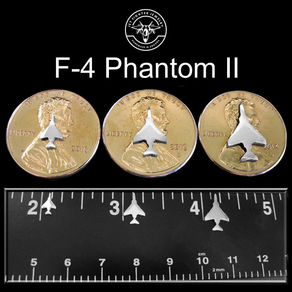 Silver silhouettes of an F-4 Fighter Jet shown on a ruler and pennies in 3 unique sizes