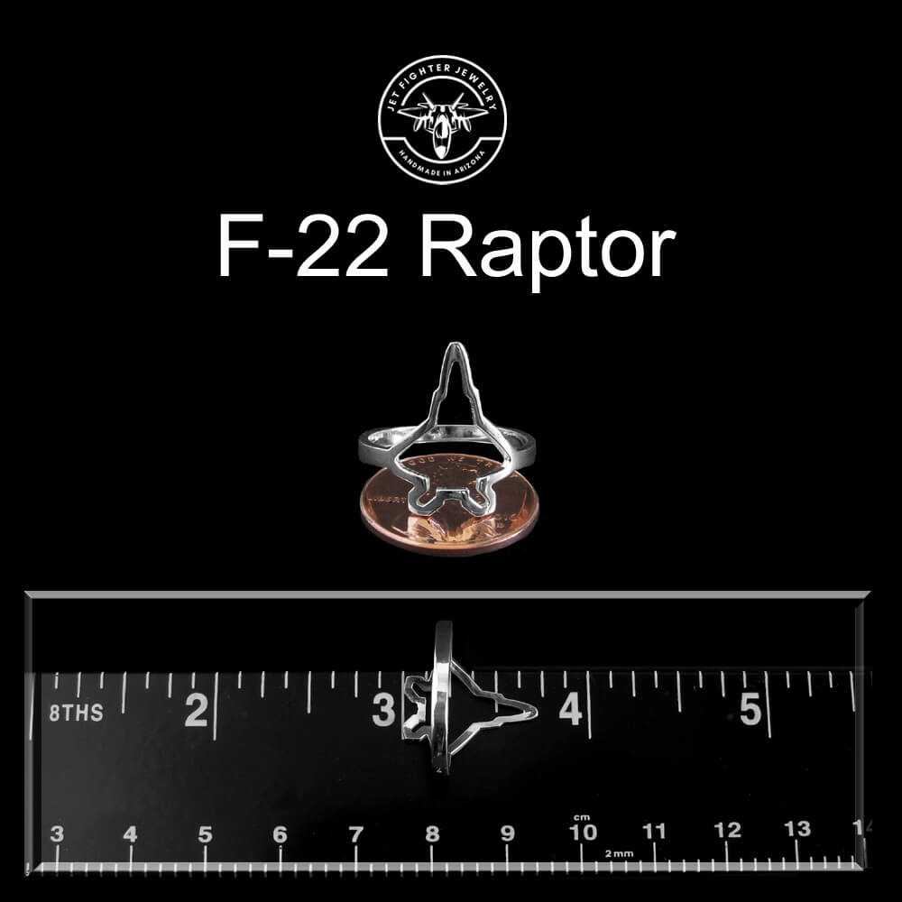 F-22 Raptor Military Jet ring with a penny and ruler for size reference on a black background.
