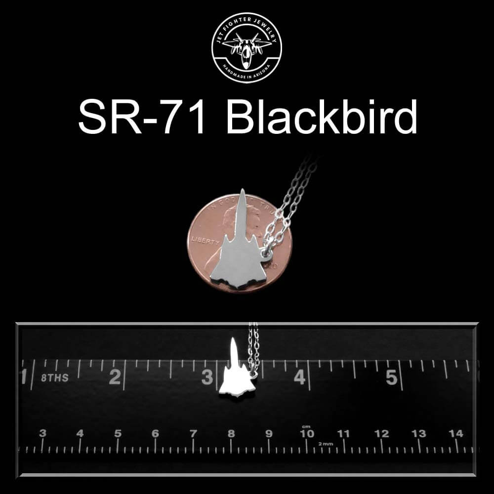 Sterling silver SR-71 Blackbird pendant necklace on a chain with a ruler for scale against a black background.