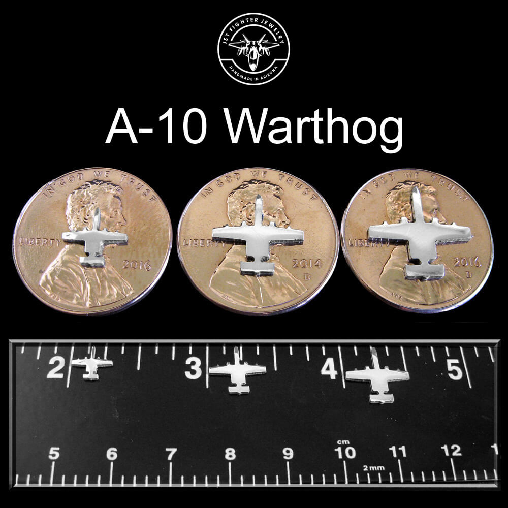 Jet Fighter Jewelry Stud Earrings Size Chart with sterling silver A-10 Warthog Airplanes shown on a ruler and penny in 3 sizes with a dark background