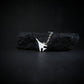 Sterling silver B-1 Lancer bomber pendant necklace resting on black rock – artisan aviation jewelry handmade in USA