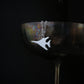 Sterling silver B-1 Lancer bomber pendant necklace displayed on wine goblet – handcrafted military aviation jewelry 