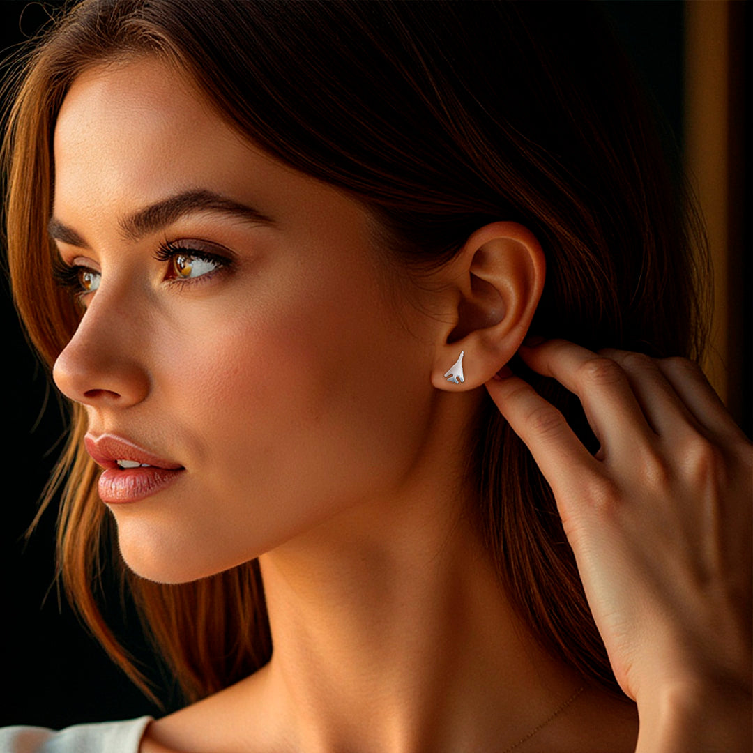 portrait of a woman wearing sterling silver B-1 earrings with a dark background