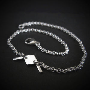 Close-up of sterling silver B-21 Raider bomber bracelet on dark background