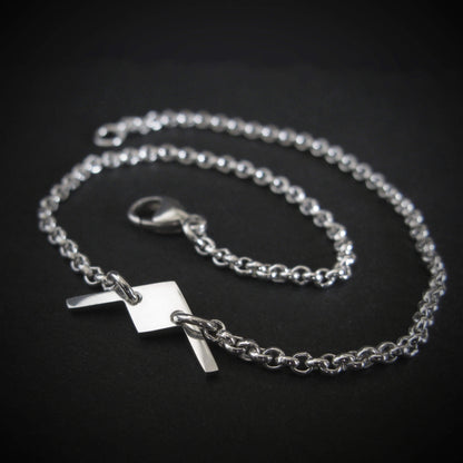 Close-up of sterling silver B-21 Raider bomber bracelet on dark background