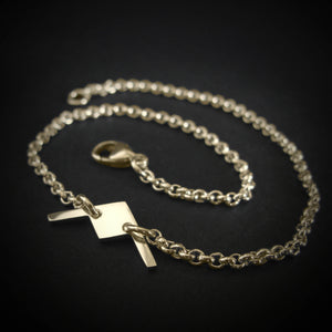 B-21 Raider bomber dainty chain bracelet in 14k gold on black background
