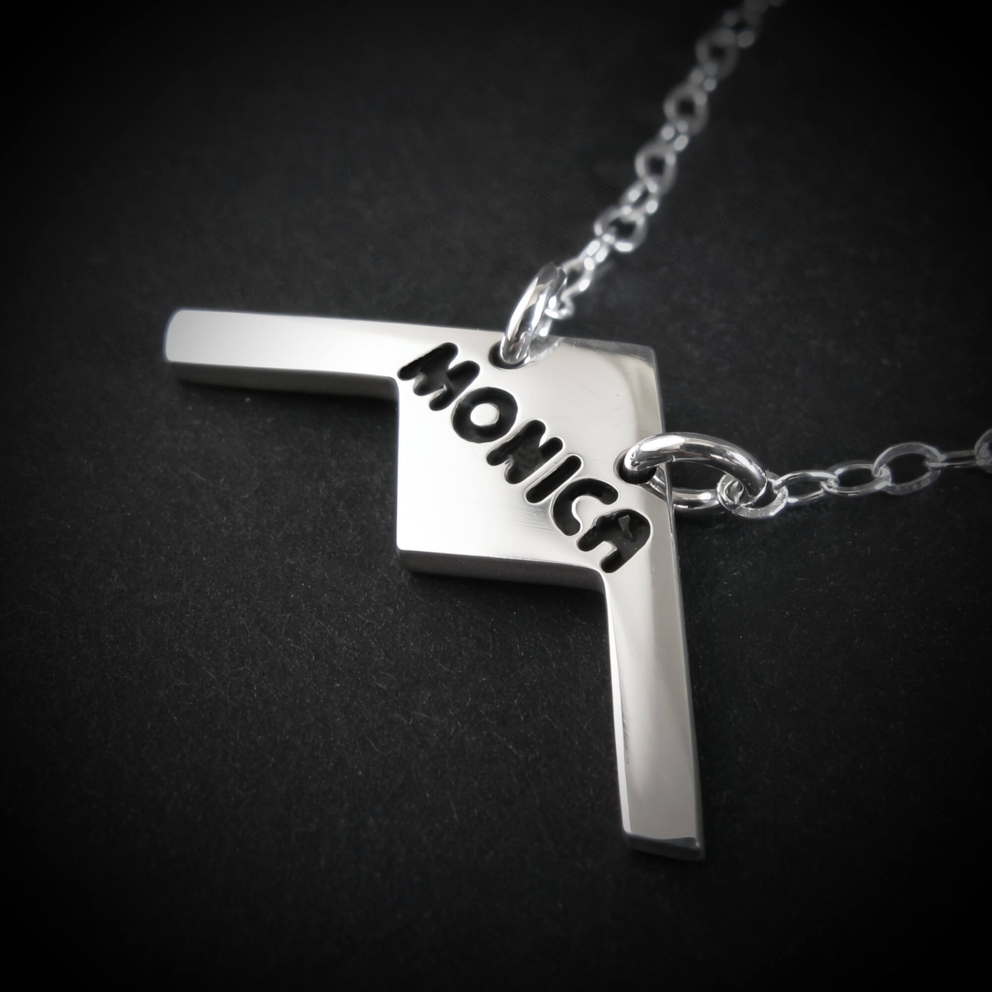 Sterling Silver B- 21 Raider Bomber Military aviation necklace with a pendant featuring the name 'Monica' on a black background