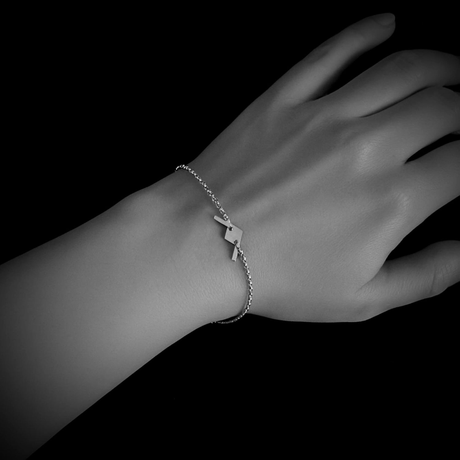B-21 Raider dainty bomber bracelet worn on wrist, sterling silver