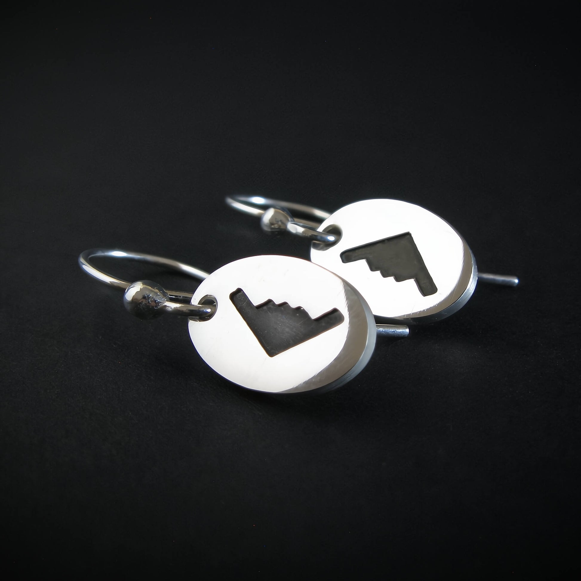 Sterling silver B‑2 Spirit bomber airplane oval dangle earrings on black background – handmade aviation jewelry