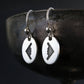 sterling silver B‑2 Spirit bomber airplane dangle earrings displayed on artistic background – handmade aviation jewelry