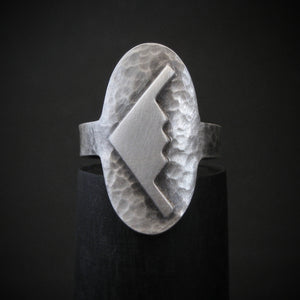 Hammered silver oval ring with a raised B-2 Bomber Military Aviation Jet silhouette on a black background