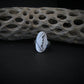 Hammered silver oval ring with a raised B-2 Bomber Military Aviation Jet on a black background with driftwood