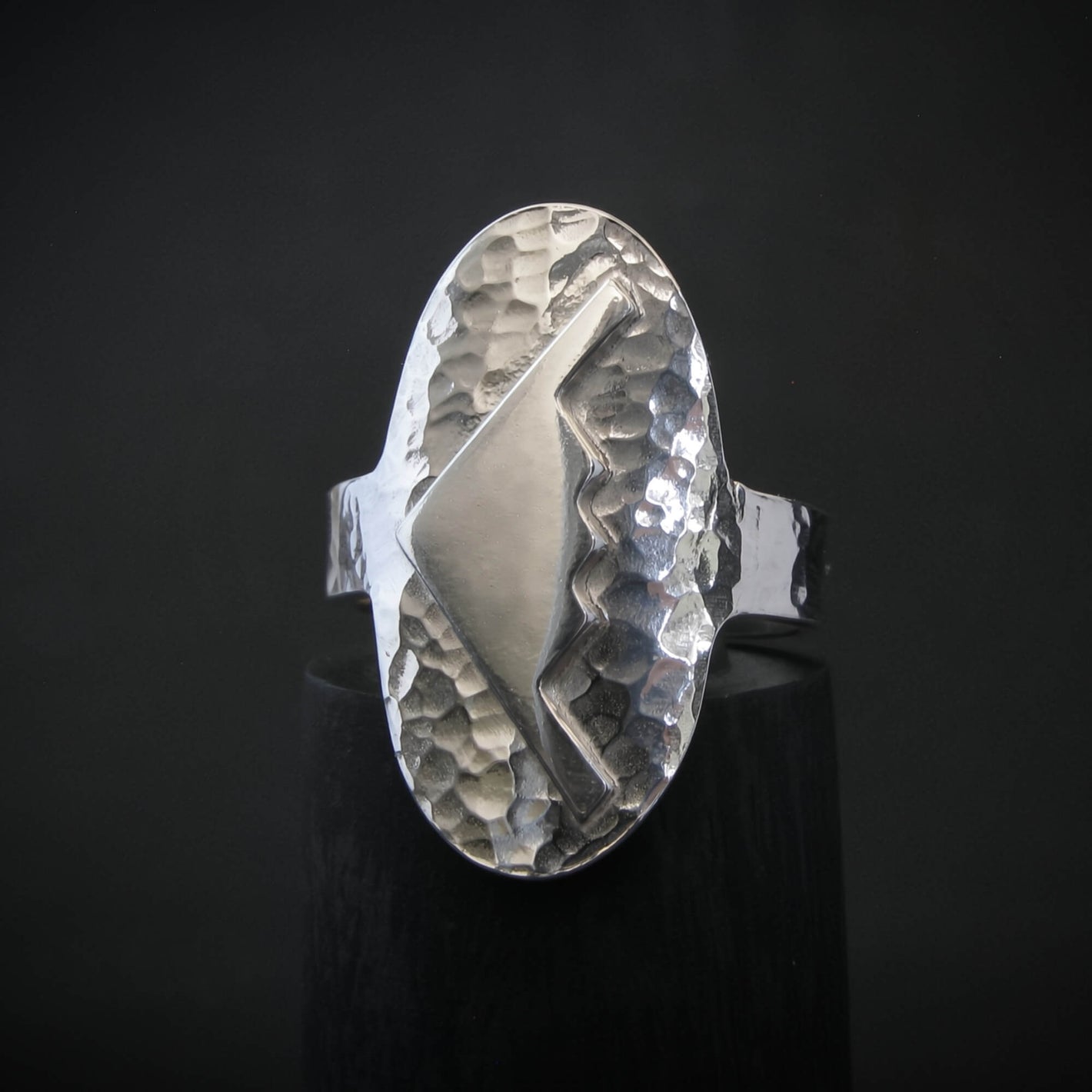 Hammered silver oval ring with a raised B-2 Bomber Military Aviation Jet silhouette on a black background