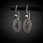 Antiqued sterling silver B‑2 Spirit bomber airplane dangle earrings on black background – handmade military aviation jewelry