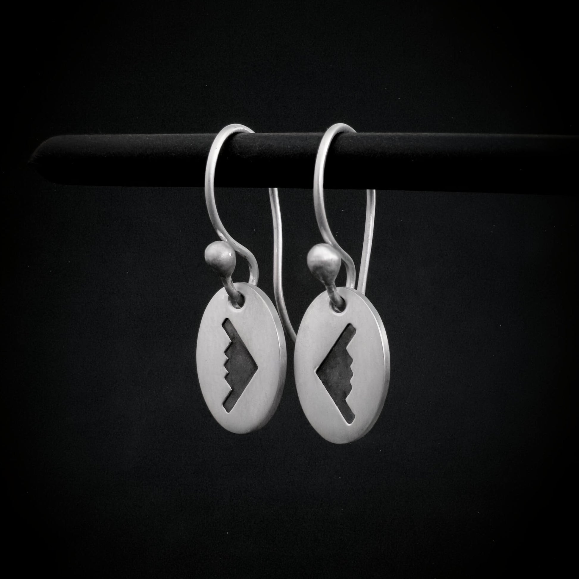 Satin sterling silver B‑2 Spirit bomber airplane dangle earrings displayed on black background – military aviation jewelry