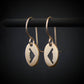 14k gold B‑2 Spirit bomber airplane oval dangle earrings on dark background – handmade aviation jewelry