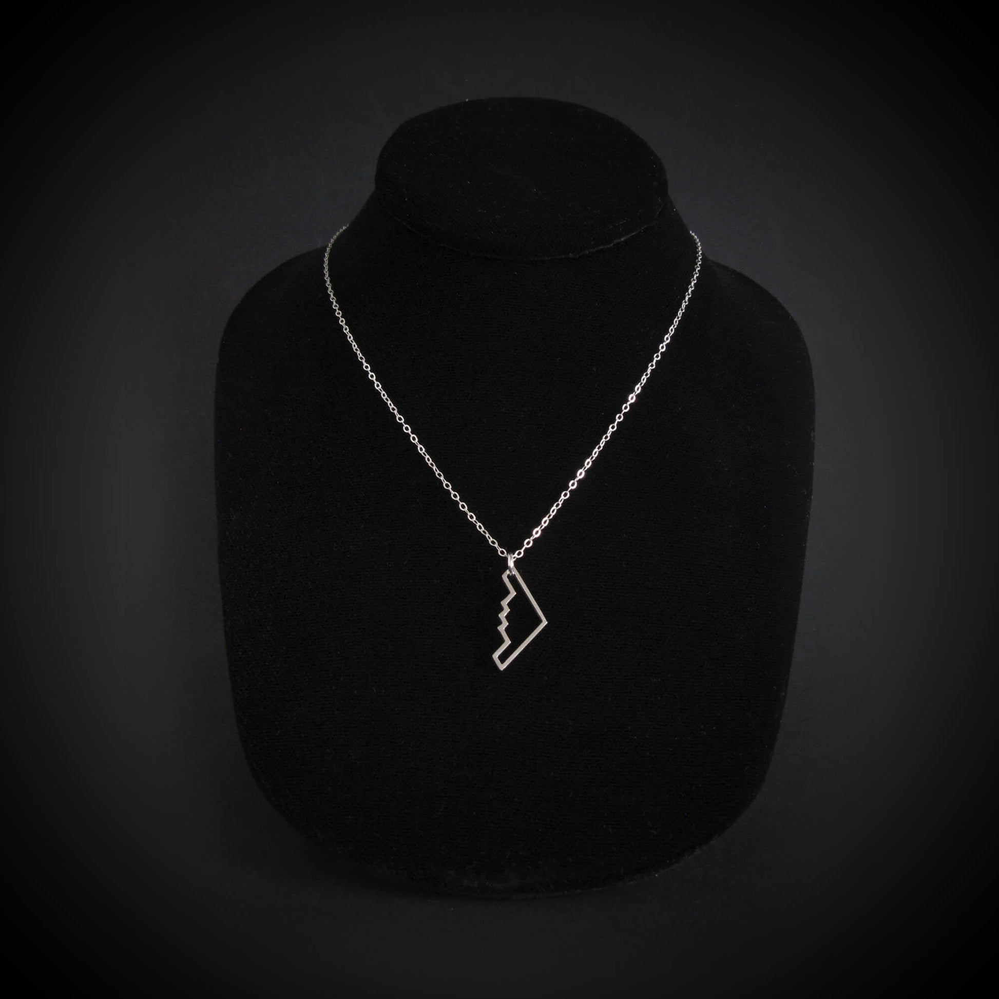 Sterling silver B‑2 Spirit bomber airplane outline pendant necklace on chain – handmade aviation jewelry displayed on bust