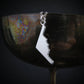 Silver B-2 Spirit Bomber Military Jet necklace pendant hanging from a reflective surface