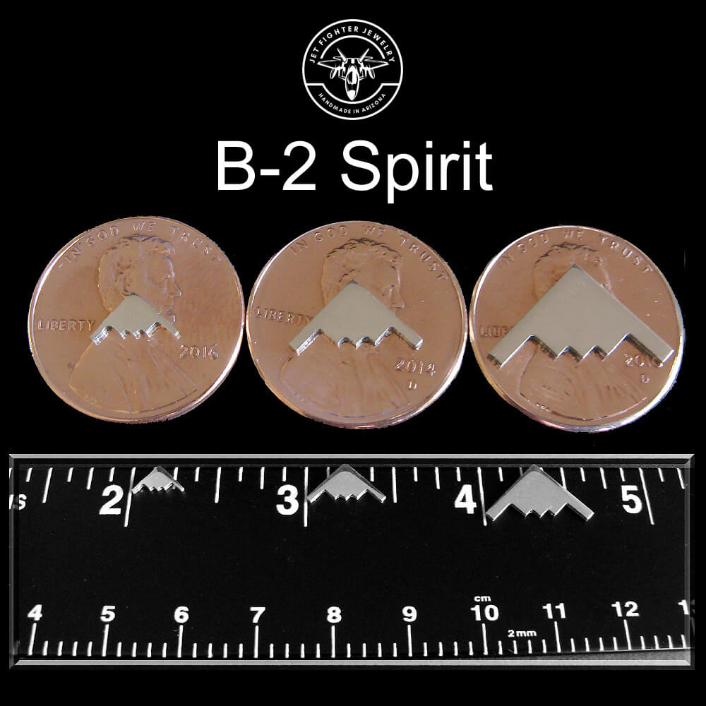 Showing three sizes of a B-2 Spirit Bomber Silhouette on a ruler and pennies for jet fighter jewelry