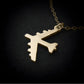 Gold B-52 Bomber pendant on a chain against a black background 