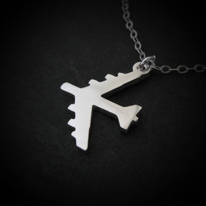 Silver B-52 Bomber pendant on a chain against a black background