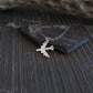 Silver B-52 Bomber Stratofortress Military Jet pendant on a dark stone surface