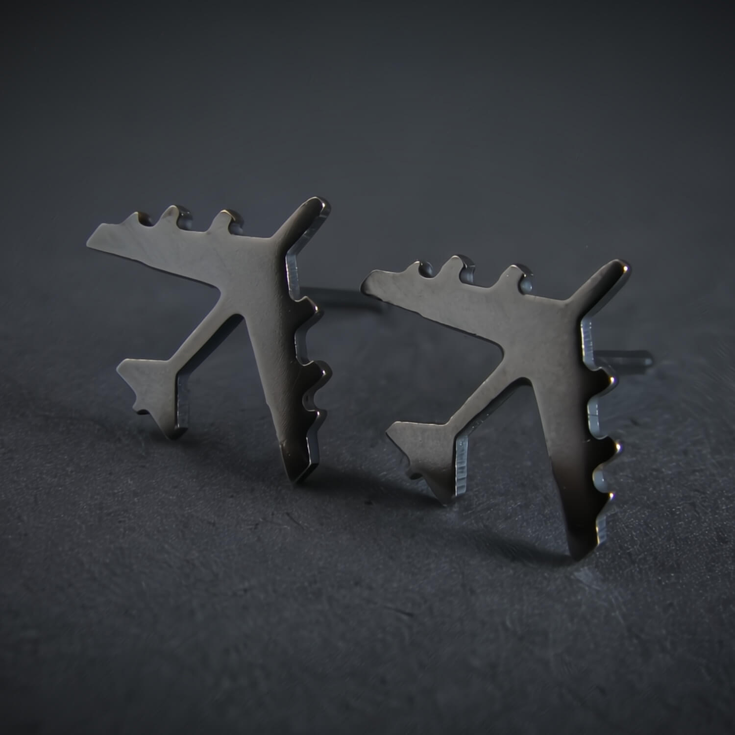 Oxidized Silver B-52 military Fighter Jet airplane shaped earrings with a dark background