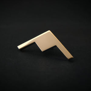 Gold B-21 Raider Bomber Jet Silhouette Tie Pin on a dark background