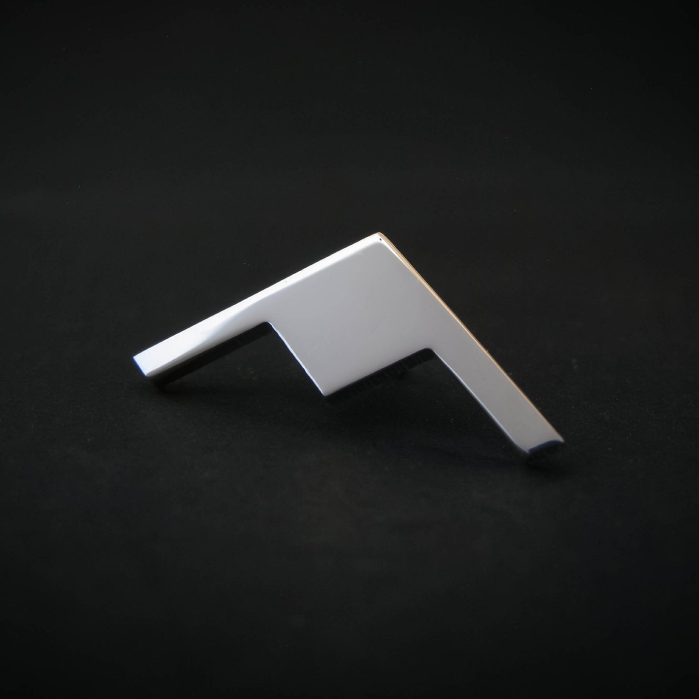 Silver B-21 Raider Bomber Jet Silhouette Tie Pin on a dark background