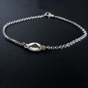 Dainty Sterling Silver bracelet with a B-2 Spirit silhouette charm on a black background