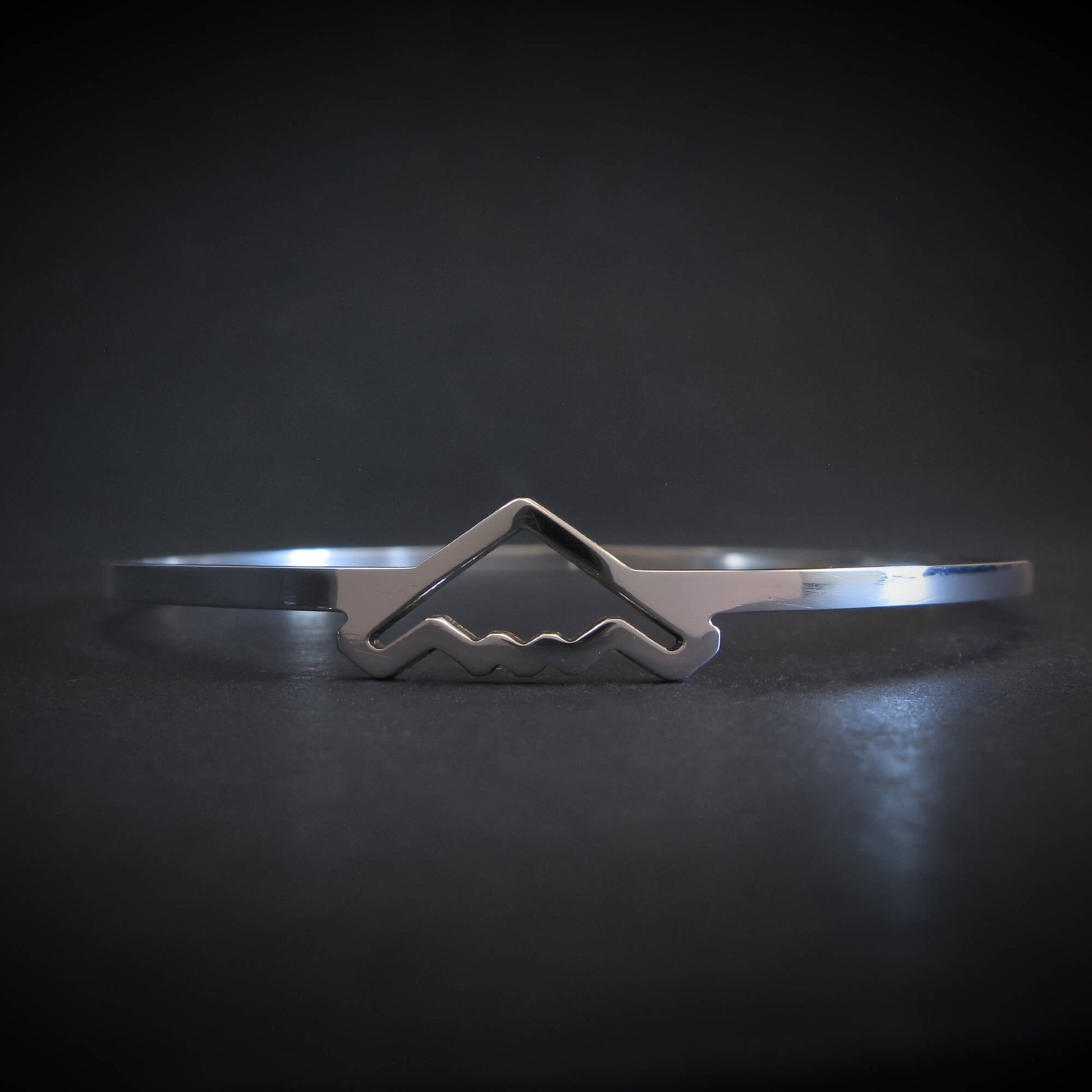 Silver bangle bracelet with B-2 Bomber Jet on a dark background