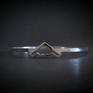 Silver bangle bracelet with B-2 Bomber Jet on a dark background