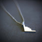 Silver B-2 Spirit Bomber Military Jet Pendant necklace on a dark background