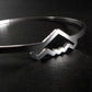 Close up of a Silver bangle bracelet with B-2 Bomber Jet on a dark background