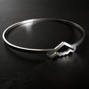 Silver bangle bracelet with B-2 Bomber Military Jet on a dark background
