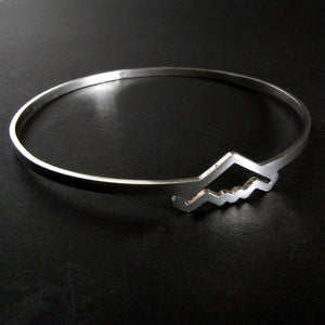 Silver bangle bracelet with B-2 Bomber Military Jet on a dark background