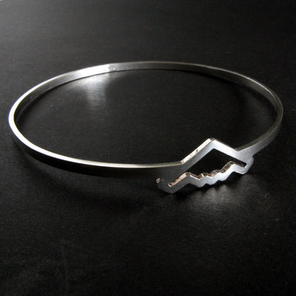 Silver bangle bracelet with B-2 Bomber Military Jet on a dark background