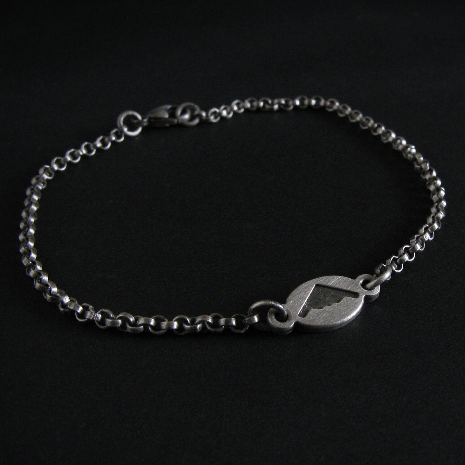 Antiqued Silver B-2 Spirit Bomber Military Jewelry bracelet with a clasp on a black background