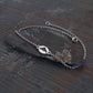 Sterling Silver bracelet with a B2 Spirit silhouette charm on a dark stone surface
