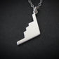 Silver B-2 Spirit Bomber Military Jet necklace pendant on a black background