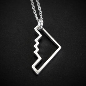 Sterling silver B‑2 Spirit bomber airplane outline pendant necklace with chain – handmade aviation jewelry on dark background