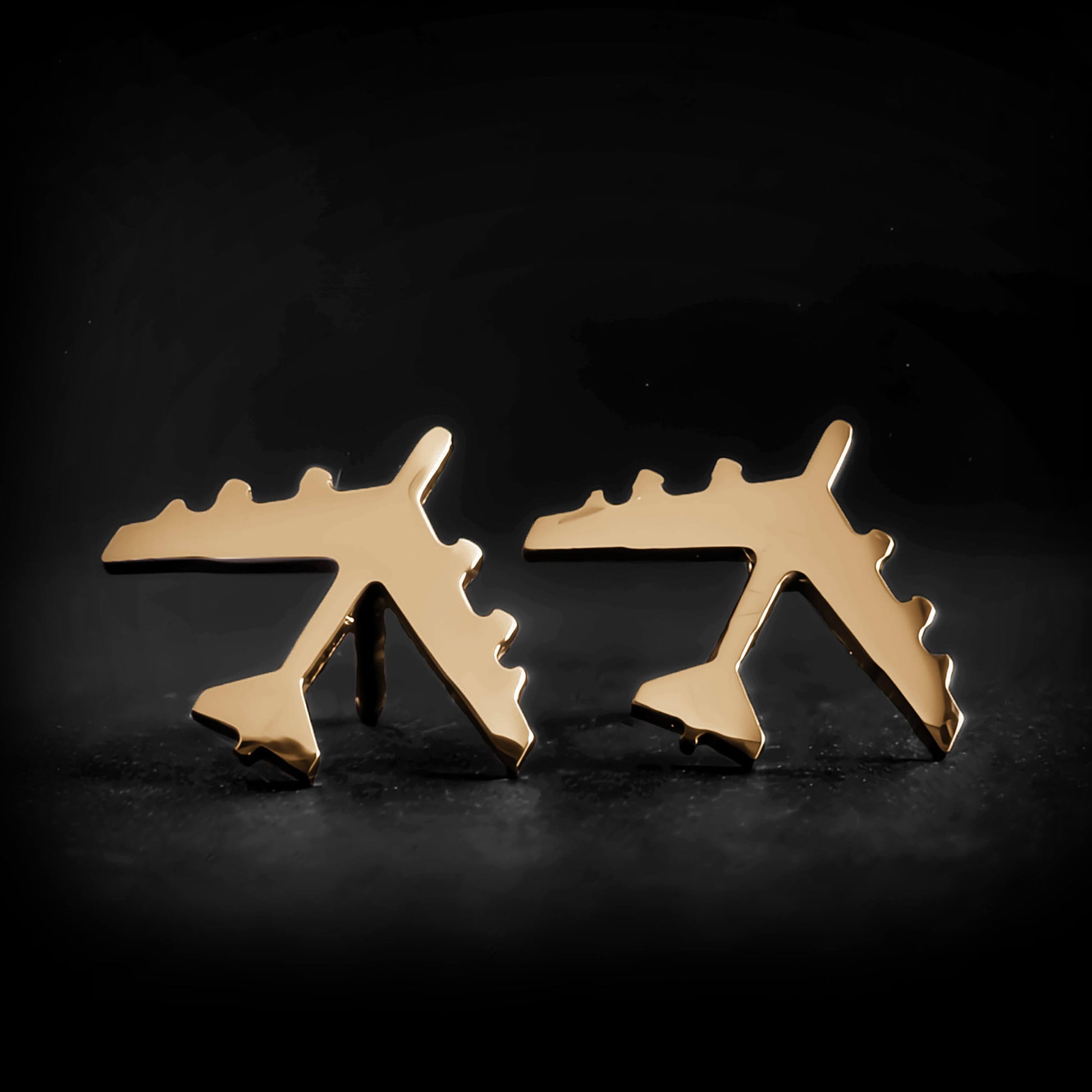 14k Gold B-52 military Fighter Jet airplane shaped earrings with a dark background