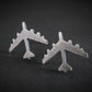 Antiqued Silver B-52 military Fighter Jet airplane shaped stud earrings with a dark background
