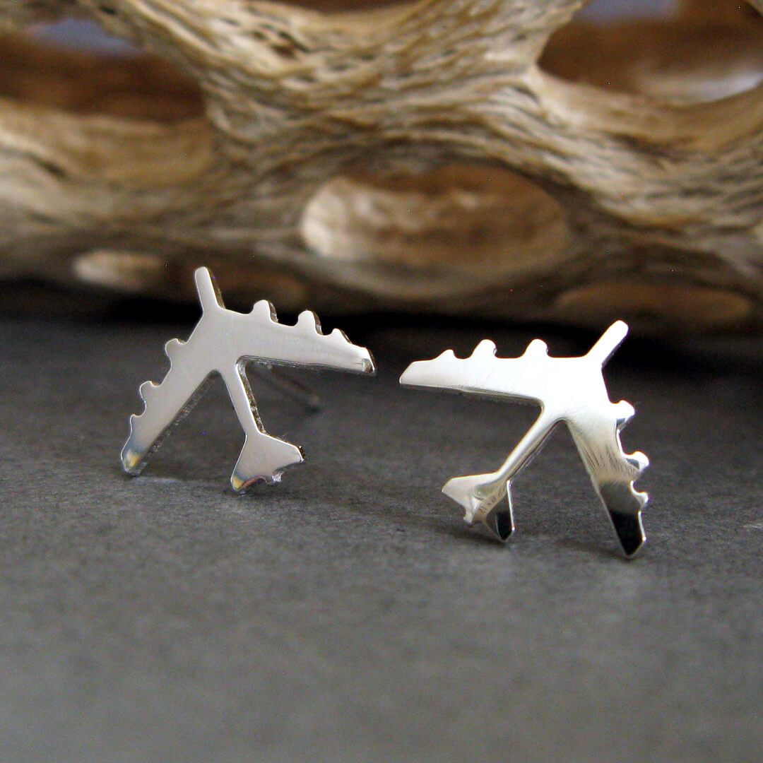 Sterling Silver B-52 military Fighter Jet airplane shaped earrings with a natural dark background