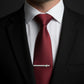 Red tie with a silver C130 Hercules Military Aircraft aviation tie clip on a white shirt and black suit.