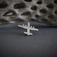 Antiqued sterling silver C-130 Hercules airplane tie tack on gray artistic background – handcrafted pilot gift