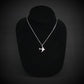 C-17 Globemaster military airplane pendant necklace in sterling silver, displayed on a black jewelry bust against a dark background.