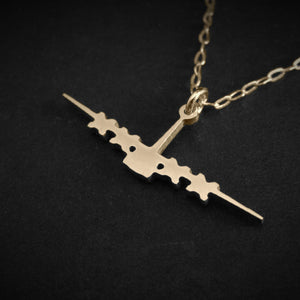 C-130 Hercules necklace in 14k gold featuring four-engine silhouette on dark background