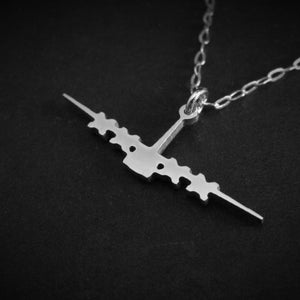 Close-up of C-130 military aviation front-view silhouette pendant in polished silver