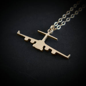 Handmade 14k gold C-17 Globemaster necklace featuring a bold front-view silhouette on black backdrop